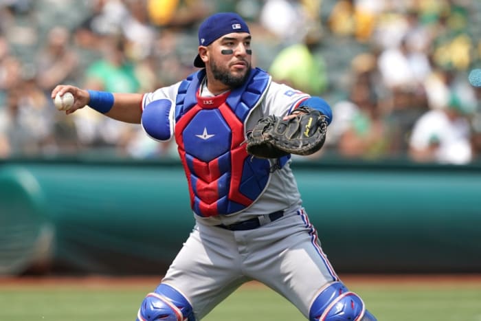 Texas Rangers C Jose Trevino throws to first base
